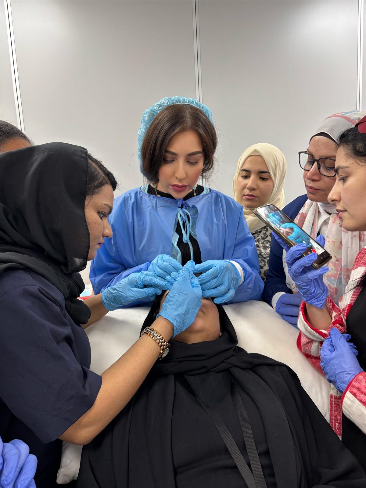 Dr. Nesma demonstrating an injectable technique to a group of practitioners
